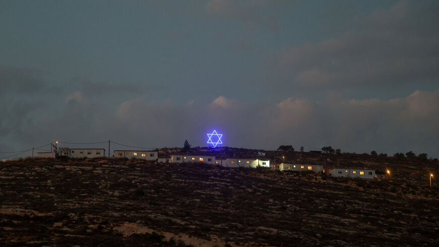 An illuminated Star of David above an Israeli settlers outpost near Ramallah, in the Israeli-occupied West Bank, August 14, 2026. REUTERS/Ammar Awad