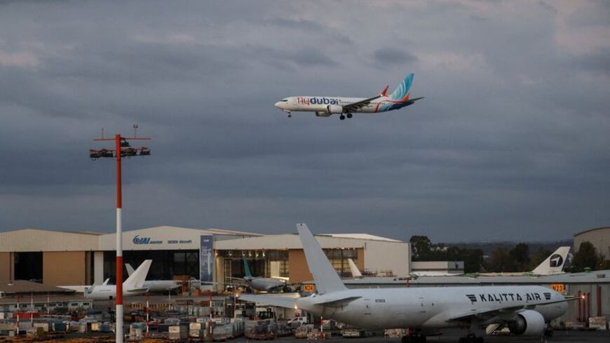 Passengers from a FlyDubai flight to Israel from United Arab Emirates that was diverted to Saudi Arabia after an emergency signal arrive at Ben Gurion International Airport