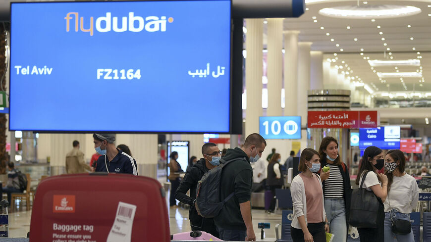 Israelis pick up their luggage upon arrival from Tel Aviv to the Dubai airport in the United Arab Emirates, on Nov. 26, 2020, on the first scheduled commercial flight operated by budget airline flydubai.