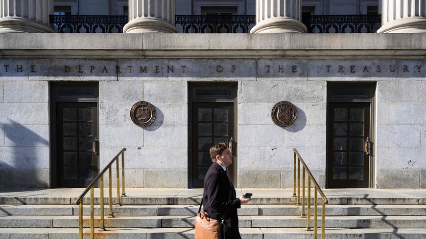 A pedestrian passes by the Treasury Building in Washington, DC on Jan. 18, 2023. 