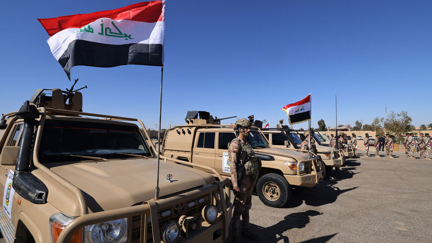 Iraqi soldiers from the new 'desert battalion' special forces stand next to military vehicles as the take part in a graduation ceremony, after months of training by the French military, at the Ain al-Asad air base in Anbar west of Baghdad on February 29, 2024. (Photo by Ahmad AL-RUBAYE / AFP) (Photo by AHMAD AL-RUBAYE/AFP via Getty Images)