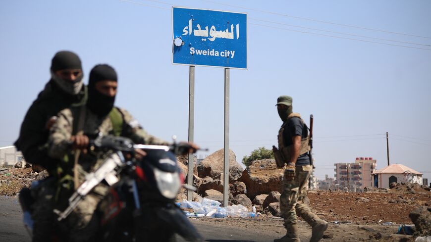 Tribal and Bedouin fighters deploy in the western neighborhood of southern Syria's predominantly Druze city of Suwayda amid clashes with Druze gunmen on July 19, 2025. 