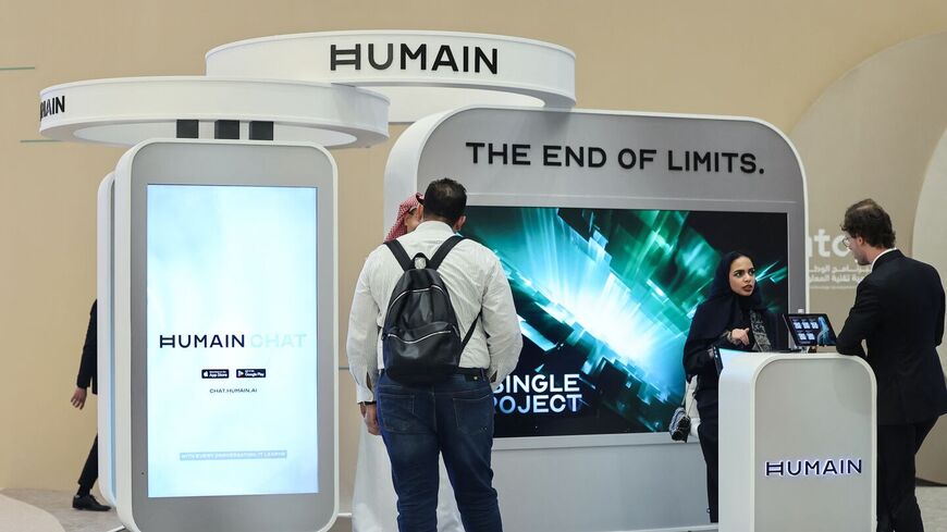 Guests stand at the booth of Saudi artificial intelligence company Humain during the Future Investment Initiative (FII) conference in Riyadh, on Oct. 29, 2025. — FAYEZ NURELDINE/AFP via Getty Images