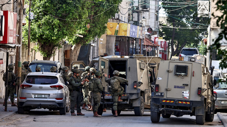 Israeli soldiers take positions during a military operation in the town of Qalqiya, in the occupied West Bank, Dec. 4, 2025. 