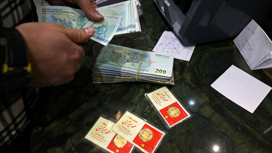 A man counts Iranian rial notes