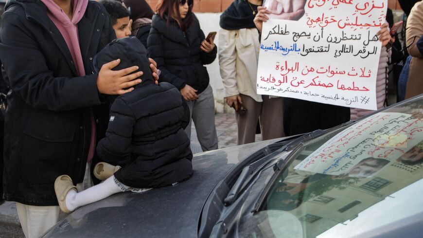 Protesters hold banners calling for child protection and justice