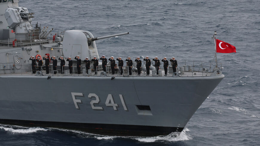 Servicemen of Yavuz class, TCG Turgutreis (F-241) warship, stand at attention on the deck as they participate in the live-fire phase of the "Blue Homeland-2026" (Mavi Vatan) tactical military exercises in the eastern Mediterranean Sea, in Antalya on April 9, 2026. 