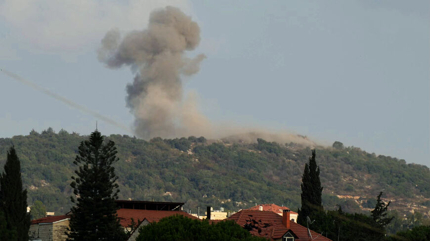 A photograph taken from the southern Lebanese area of Nabatieh shows smoke as it rises from the site of Israeli strikes that targeted the hilltops of the mountainous area of the strategic Ali al-Taher Ridge on Aug. 14, 2026.  