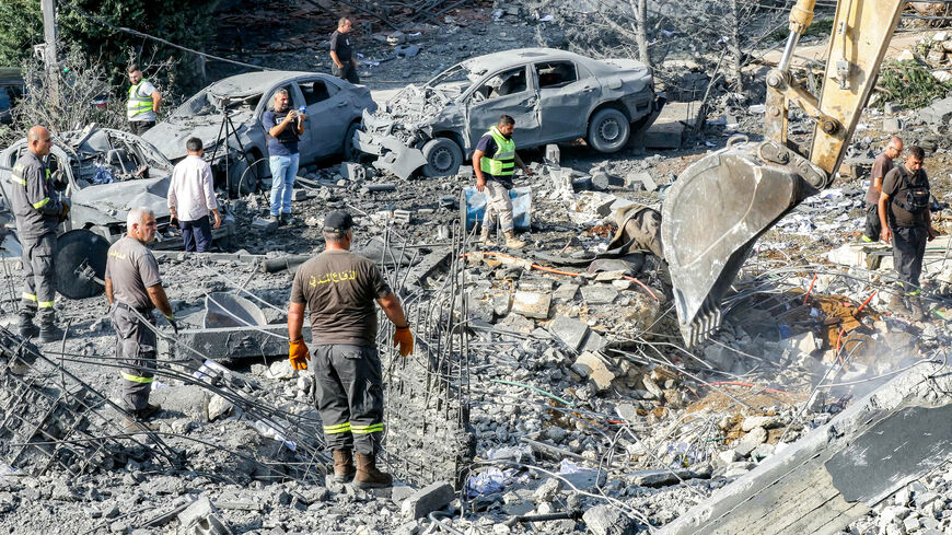 An excavator digs as rescuers search for survivors amid the rubble following an overnight Israeli airstrike on the village of Kfar Roummane, southern Lebanon, Sept. 7, 2026.