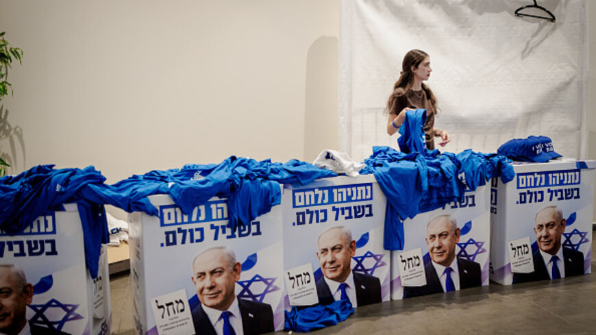 TEL AVIV, ISRAEL - SEPTEMBER 17: A campaign worker organizes blue Likud t-shirts and caps over merchandise display boxes printed with portraits of Prime Minister Benjamin Netanyahu during a Likud election event at Expo Tel Aviv on September 17, 2026 in Tel Aviv, Israel. The right-wing Likud party, led by Prime Minister Benjamin Netanyahu, is seeking to retain power in Israel's upcoming national election, due to be held on October 27. Recent polling suggests Likud and the ruling coalition face a tight race a