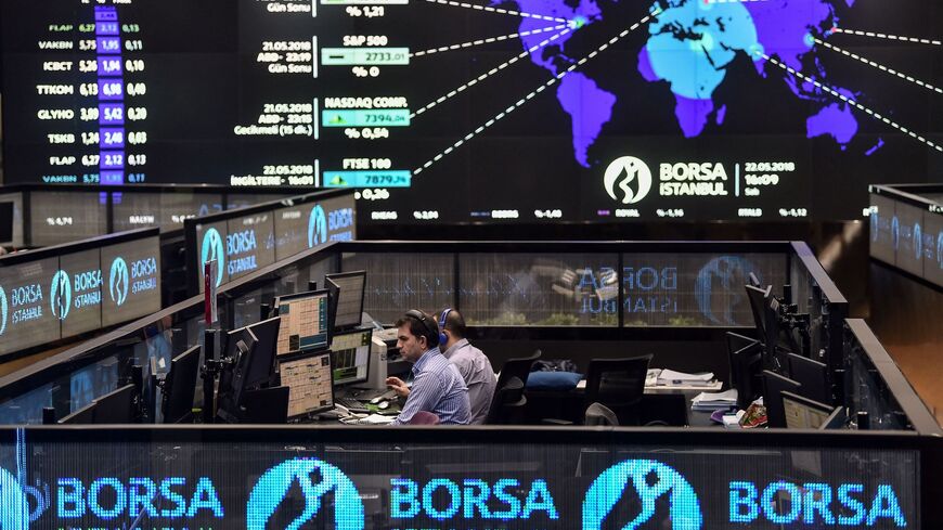 Traders work at their desks on the floor of the Borsa Istanbul 