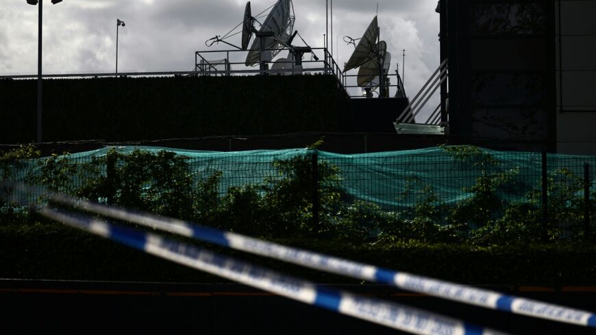 UK police tape cordoned off a warehouse park housing offices of the Persian-language TV station, Iran International, in northwest London, in April