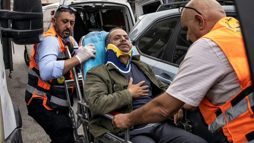 Palesitnian first responders carry into an ambulance AFP photographer Jaafar Ashtiyeh after he was beaten by Israelis in Aqraba in the Israeli-occupied West Bank