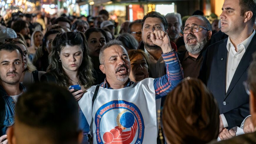 On the eve of the defection of Izmir Mayor Cemil Tugay, protesters gathered in the city chanting angry slogans against him