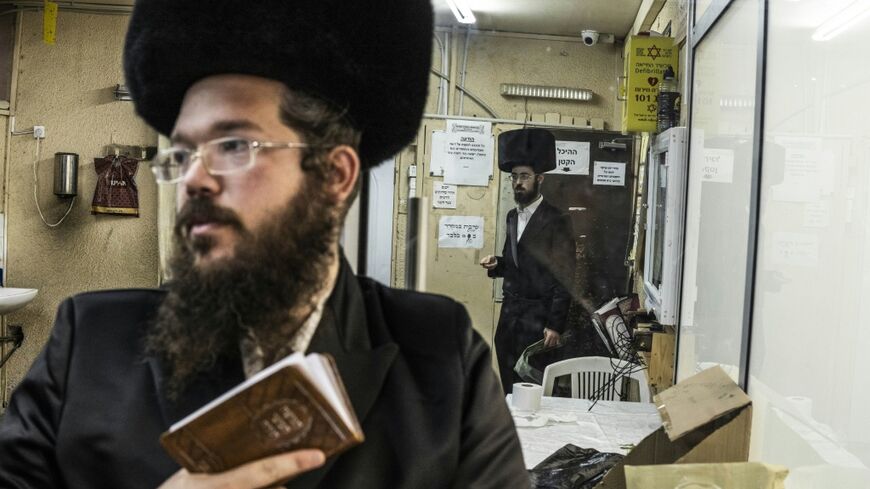 Ultra-Orthodox Jewish men pray in a synagogue in Arad on October 1, 2026. As Israelis prepare to vote in parliamentary elections on October 27, tensions in Arad have become a microcosm of a broader national debate.