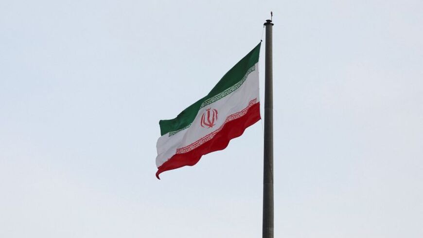 An Iranian flag flutters in a park in Tehran