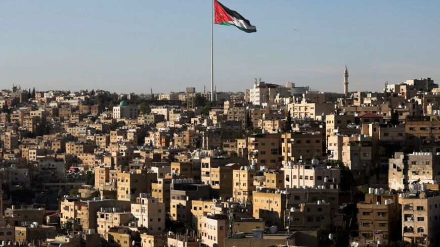 A Jordanian flag flies over the capital city, Amman