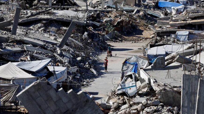 Palestinians live amid the rubble of buildings destroyed during the war, in Gaza City