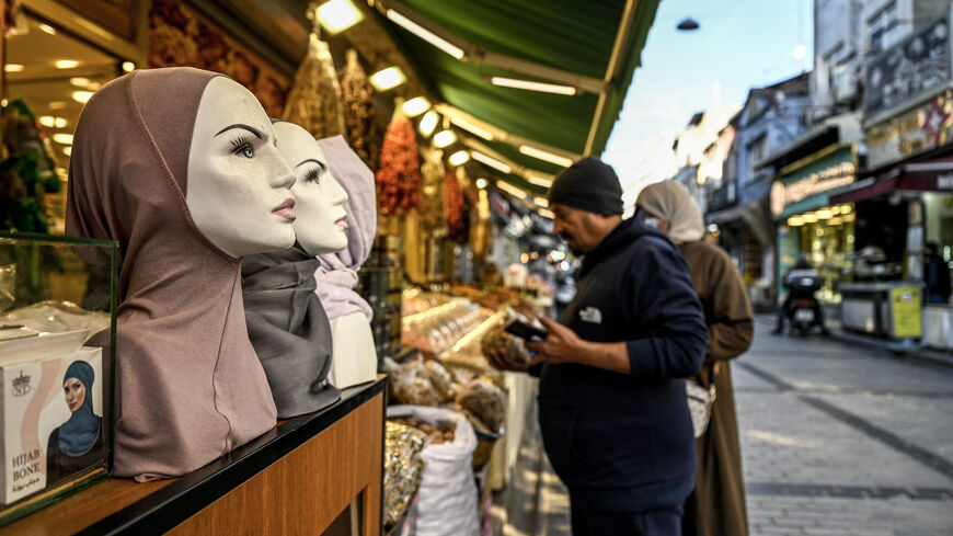 A shop owner assists one of his customers at Malta bazaar in the Fatih district in Istanbul, on Dec. 6, 2024.