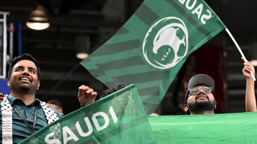 Saudi Arabia football supporters wave flags