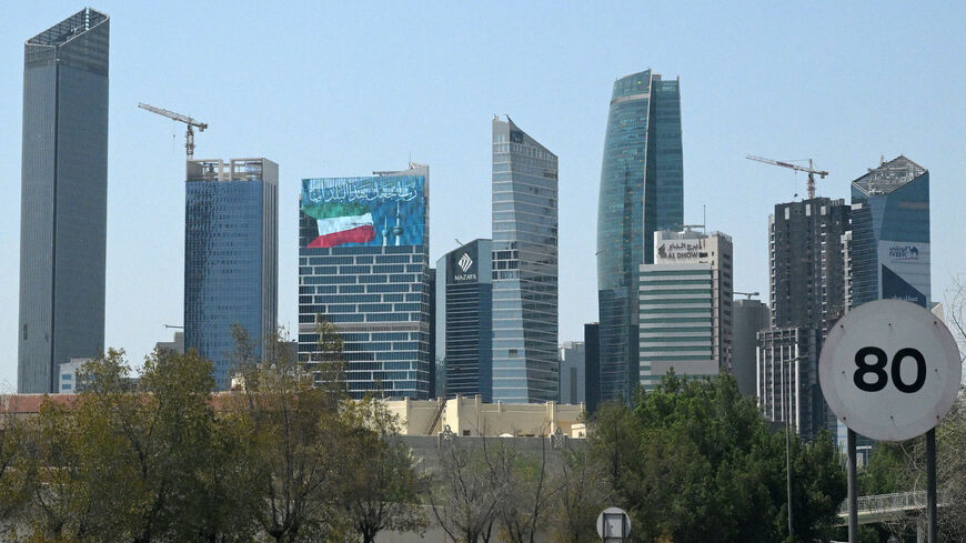 A large screen displays a verse from the Koran reading "My Lord, make this city secure," alongside the Kuwaiti flag and the landmark Kuwait Towers, on a skyscraper in Kuwait City on Sept. 2, 2026.