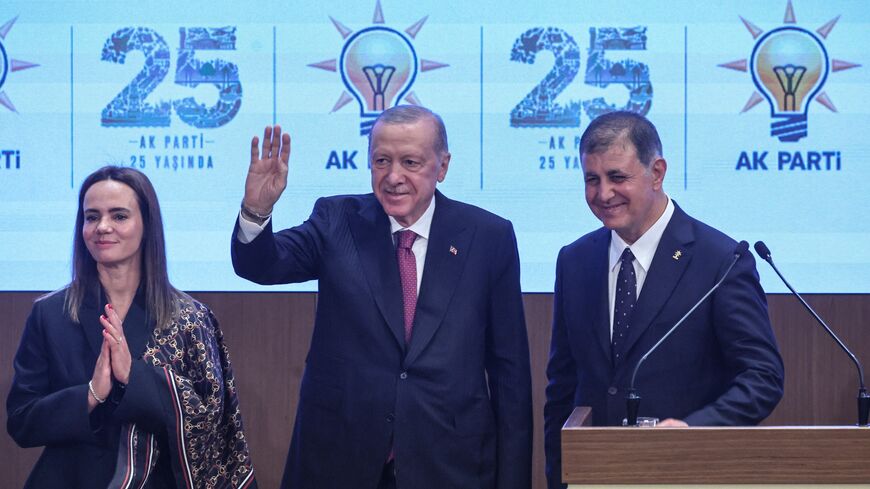 Izmir Mayor Cemil Tugay (R) his wife Oznur Tugay and Turkish President Recep Tayyip Erdogan acknowledge the audience after the mayor announced joining the ruling Justice and Development Party during a meeting with AKP lawmakers in Ankara, on Oct. 7, 2026. 