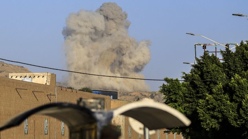 A plume of smoke rises during a reported airstrike by the Saudi-led coalition on the Houthi-controlled Yemeni capital, Sanaa, on Oct. 9, 2026. 