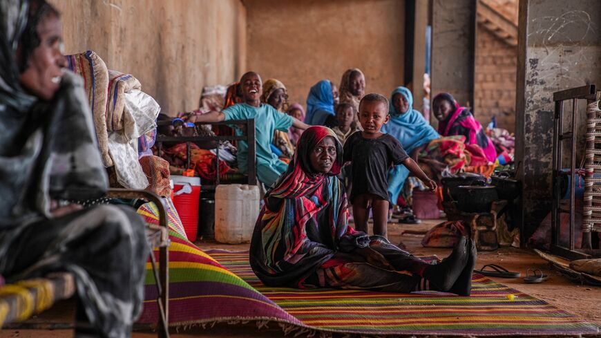 Displaced families sit together on mats and bedding inside a communal shelter in Al-Ubayyid, North Kordofan, Sudan, on March 30, 2026. 