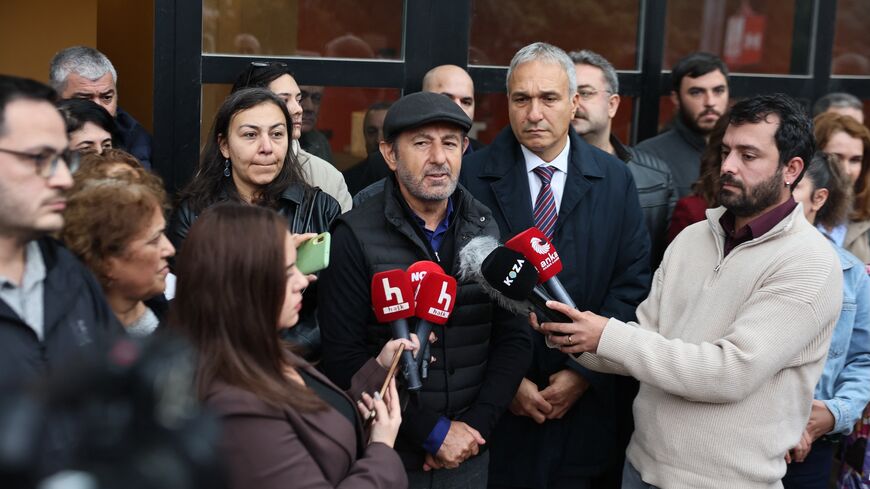 Serhan Asker, General Program Coordinator at Halk TV, makes a statement outside the Ankara branch of Turkey's most-watched news channel, Halk TV.