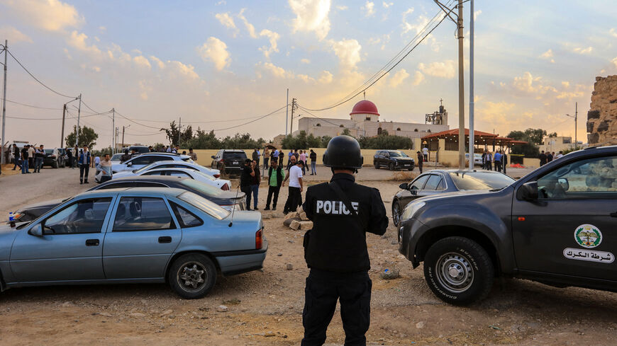 People and security forces gather outside a Greek Orthodox Church in the village of Hammoud in Jordan's Karak governorate following a shooting on October 23, 2026. 