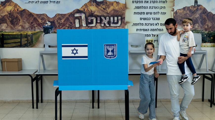 ahar Mahluf, accompanied by his children Adir and Noya, casts his vote during Israel's general elections on October 27, 2026 in Hadera, Israel. Israeli voters are heading to the polls to elect 120 members of the Knesset, which will determine the make-up of the government that succeeds incumbent Prime Minister Benjamin Netanyahu's right-wing coalition. The legislative elections are the first to be held since the Hamas-led attacks against Israel on October 7, 2023. (Photo by Amir Levy/Getty Images)