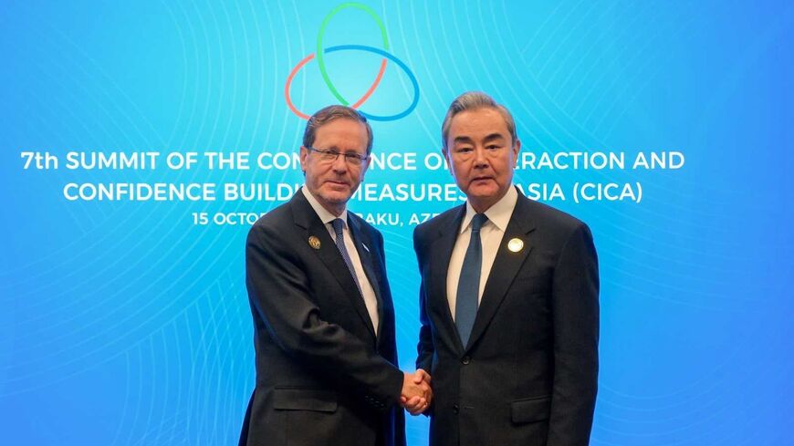Israeli President Isaac Herzog and Chinese Foreign Minister Wang Yi at the  the Conference on Interaction and Confidence-Building Measures in Asia, Baku, Azerbaijan, Oct. 15, 2026.