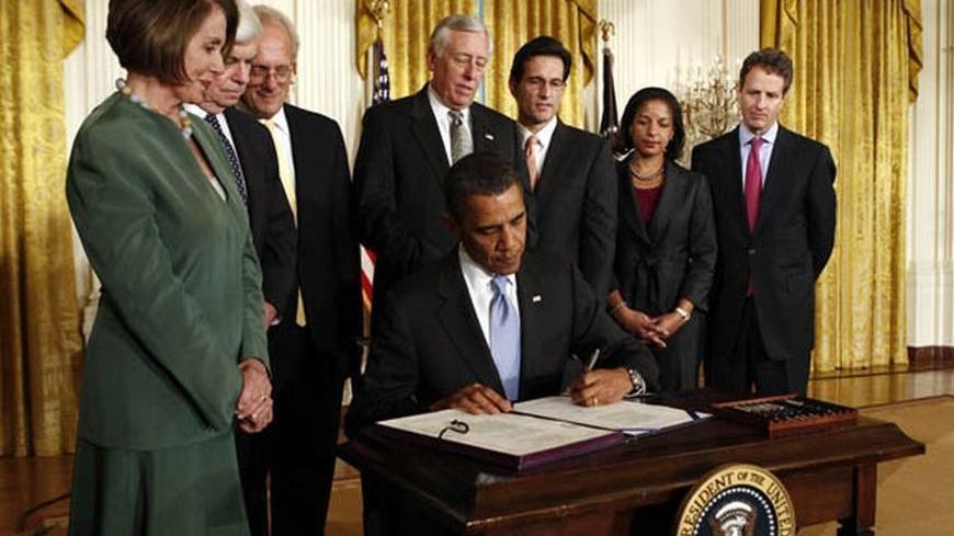 U.S. President Barack Obama signs the Iran Sanctions Act at the White House in Washington July 1, 2010. The House of Representatives and the Senate approved the new sanctions bill last week that penalizes companies supplying Iran with gasoline as well as international banks involved with Iran's Islamic Revolutionary Guard Corps.
REUTERS/Kevin Lamarque (UNITED STATES - Tags: POLITICS)