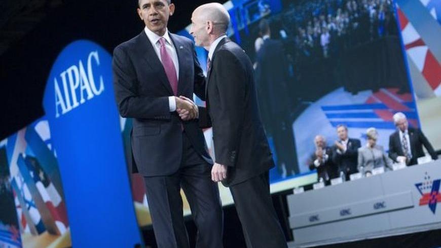 U.S. President Barack Obama (L) shakes hands with American Israel Public Affairs Committee (AIPAC) President Lee Rosenberg after delivering remarks at the AIPAC's annual policy conference in Washington March 4, 2012. REUTERS/Jonathan Ernst (UNITED STATES - Tags: POLITICS)
