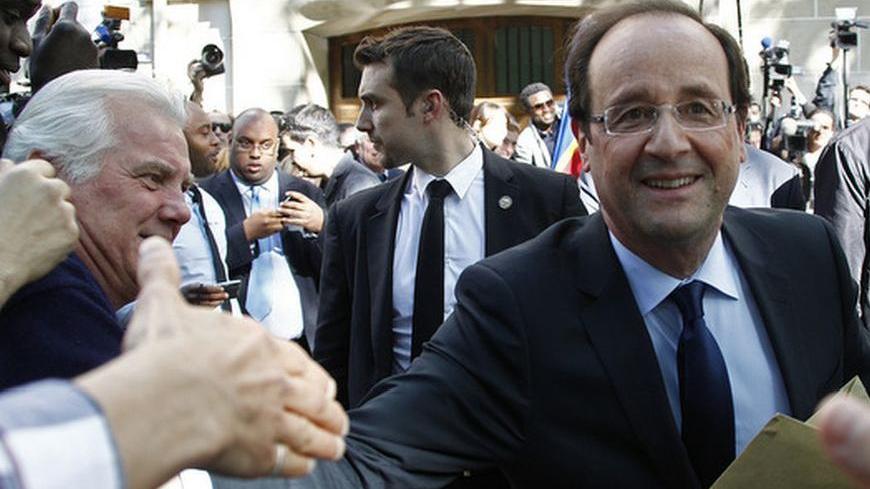 France's newly-elected President Francois Hollande leaves his former campaign headquarters in Paris May 14, 2012. REUTERS/Jacky Naegelen (FRANCE - Tags: POLITICS)