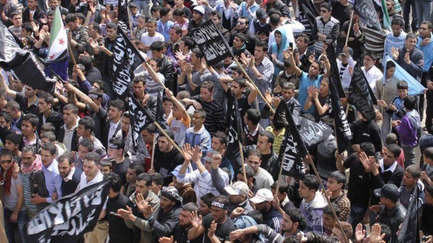 Syrian and Lebanese protesters chant slogans against Syrian President Bashar al-Assad during a protest organized by Sunni Muslim Salafist group in solidarity with Syria's anti-government protesters, in Wadi Khaled village, north Lebanon April 1, 2012.             REUTERS/Roula Naeimeh    (LEBANON - Tags: CIVIL UNREST POLITICS RELIGION)