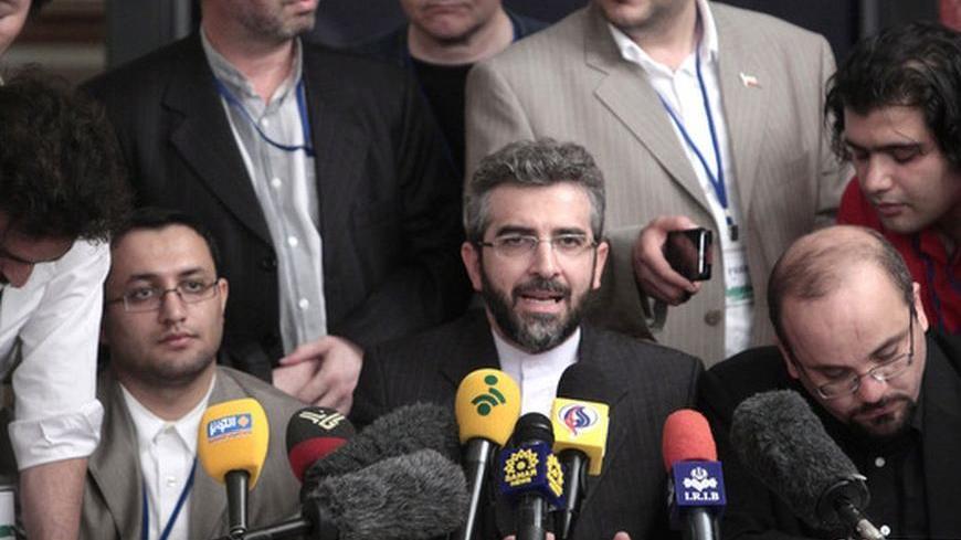 Iran's negotiator Ali Bagheri (C, bottom) attends a meeting with the media in Moscow, June 18, 2012. Talks on Iran's nuclear program on Monday were difficult and included a tense exchange of views, a European Union spokesman said.  REUTERS/Sergei Karpukhin  (RUSSIA - Tags: POLITICS ENERGY)