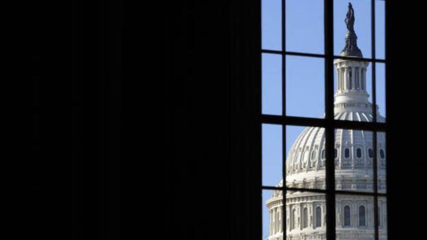 The dome of the US Capitol, where President Barack Obama will deliver his first address to a joint session of congress, is visible through a window on Capitol Hill in Washington, February 24, 2009.  REUTERS/Jonathan Ernst   (UNITED STATES)