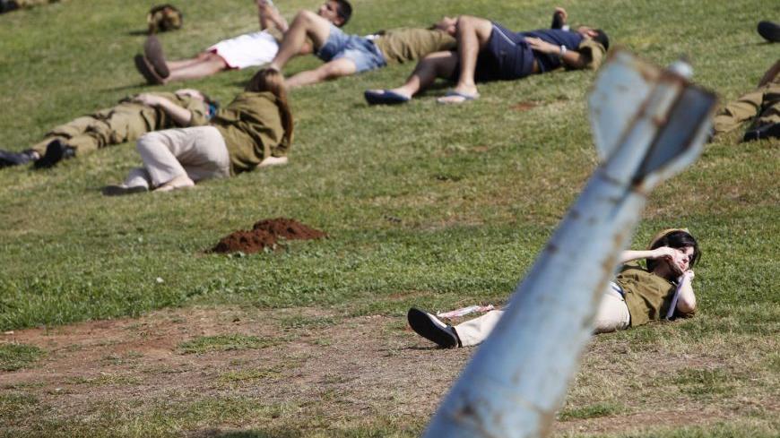Israeli soldiers playing the roles of mock victims lie on the ground during a drill simulating a missile attack in Holon near Tel Aviv November 3, 2011. Israel staged a mass drill on Thursday, simulating a missile attack in the centre of the country at a time of intense speculation that the Jewish state could launch strikes on Iran, although the military dismissed any link. REUTERS/Nir Elias (ISRAEL - Tags: POLITICS MILITARY)