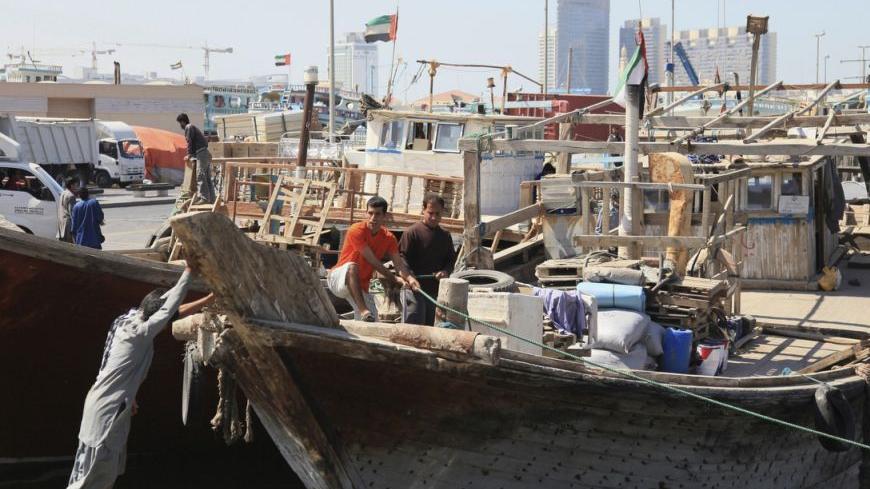 Workers load goods onto ships at the port in Deira, February 27, 2012. Financial sanctions imposed over Iran's disputed nuclear programme have dealt a heavy blow to its foreign trade. Since late last year the United States has stepped up its use of anti-money laundering legislation to make it legally dangerous for banks that have any U.S. business to maintain ties with Iran. As a result, Iranian firms have been frozen out of much of the global banking system which finances trade. It is difficult or impossib