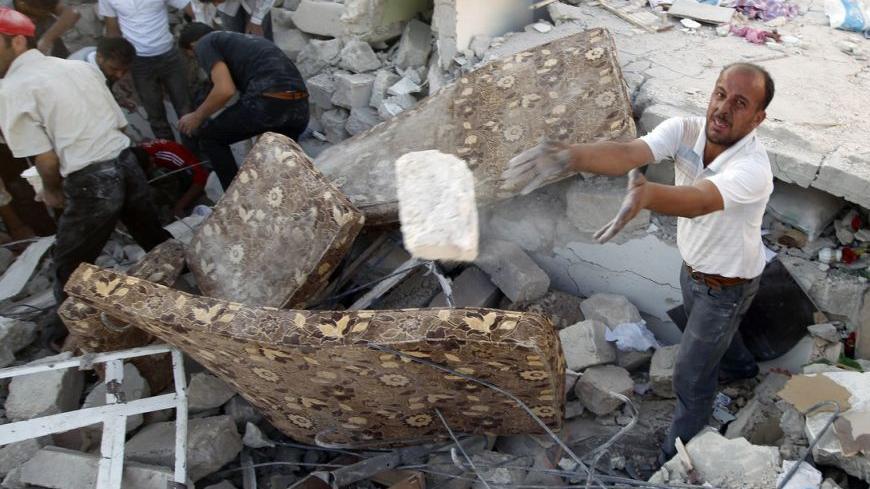A man searches for the bodies of people who were killed during a recent Syrian Air Force air strike in Azaz, some 47 km (29 miles) north of Aleppo, August 15, 2012. 
 REUTERS/Goran Tomasevic (SYRIA - Tags: CIVIL UNREST MILITARY POLITICS CONFLICT)