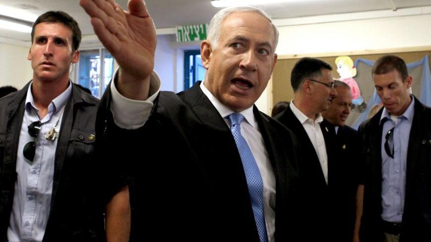 Israeli Prime Minister Benjamin Netanyahu (C) is surrounded by security guards as he gestures during a visit to a kindergarten on the first day of school in Jerusalem August 27, 2012. REUTERS/Gali Tibbon/Pool (JERUSALEM - Tags: POLITICS EDUCATION)