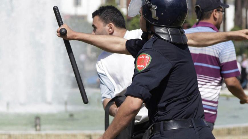A police officer clashes with a protester, as police attempt to disperse anti-government protesters and young unemployed graduates, during a demonstration in Rabat September 20, 2012. REUTERS/Stringer (MOROCCO - Tags: POLITICS CIVIL UNREST BUSINESS EMPLOYMENT TPX IMAGES OF THE DAY)