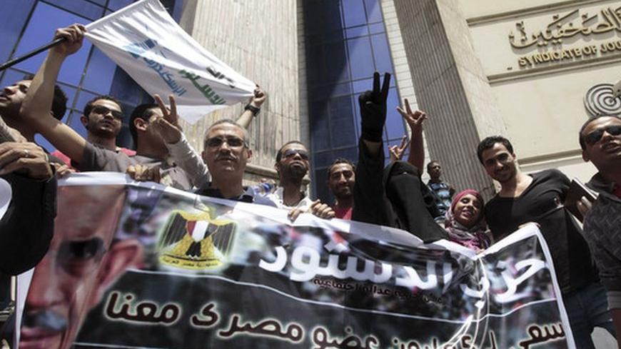 Supporters are seen outside the building where Mohamed ElBaradei is launching his new party named "Dustour" (Constitution) during a news conference in Cairo April 28, 2012. REUTERS/Mohamed Abd El Ghany (EGYPT - Tags: POLITICS ELECTIONS)