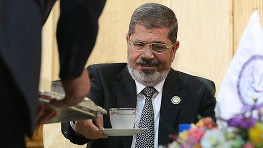 Egypt's President Mohamed Mursi is seen before his meeting with Iran's Executive Vice President Hamid Baghai at Mehrabad airport in Tehran ahead of the 16th summit of the Non-Aligned Movement, August 30, 2012. Mursi arrived in Tehran on Thursday, the first Egyptian leader to visit Iran since its Islamic revolution in 1979. REUTERS/Roohollah Vahdati/ISNA (IRAN - Tags: POLITICS) FOR EDITORIAL USE ONLY. NOT FOR SALE FOR MARKETING OR ADVERTISING CAMPAIGNS. THIS IMAGE HAS BEEN SUPPLIED BY A THIRD PARTY. IT IS DI