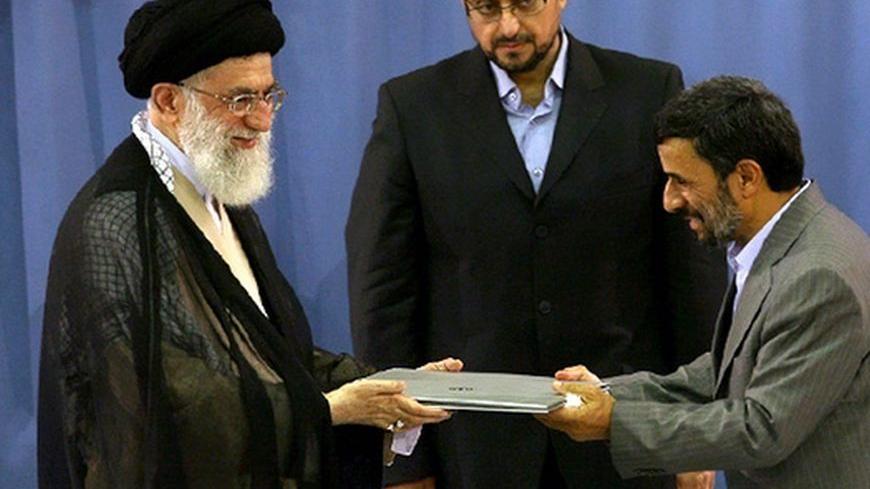 EDITORS' NOTE: Reuters and other foreign media are subject to Iranian restrictions on their ability to film or take pictures in Tehran

Iranian President Mahmoud Ahmadinejad (R) receives a certificate declaring him as President of the Islamic Republic of Iran from Supreme Leader Ayatollah Ali Khamenei in Tehran August 3, 2009. Iran's supreme leader formally approved the second term presidency of Ahmadinejad on Monday after a disputed election that leading reformists say was rigged to ensure the incumbent'