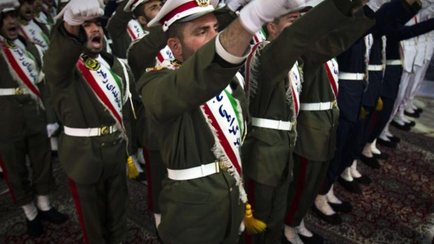 EDITORS' NOTE: Reuters and other foreign media are subject to Iranian restrictions on leaving the office to report, film or take pictures in Tehran.

Iranian soldiers shout anti-U.S. slogans during the anniversary ceremony of Iran's Islamic Revolution at the Khomeini shrine in the Behesht Zahra cemetery, south of Tehran, February 1, 2012. REUTERS/Raheb Homavandi  (IRAN - Tags: POLITICS MILITARY ANNIVERSARY)