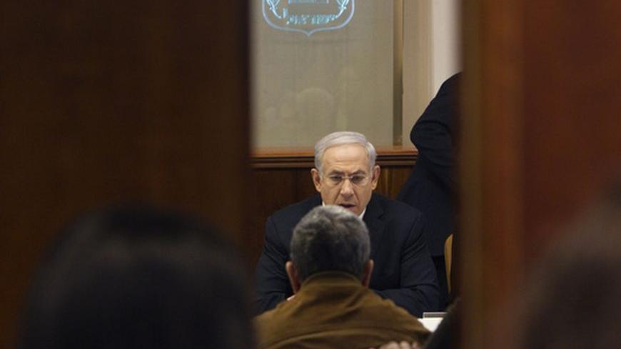 Israel's Prime Minister Benjamin Netanyahu sits across from Defence Minister Ehud Barak during the weekly cabinet meeting in Jerusalem March 11, 2012. Israeli aircraft on Sunday killed three Palestinians medical sources in Gaza said, and militants fired rockets into Israel in a third day of cross-border attacks. "We are at the height of this round (of violence), " Netanyahu told his cabinet. "We have exacted a heavy price from them and we will continue to act as needed."  REUTERS/Ronen Zvulun (JERUSALEM - T