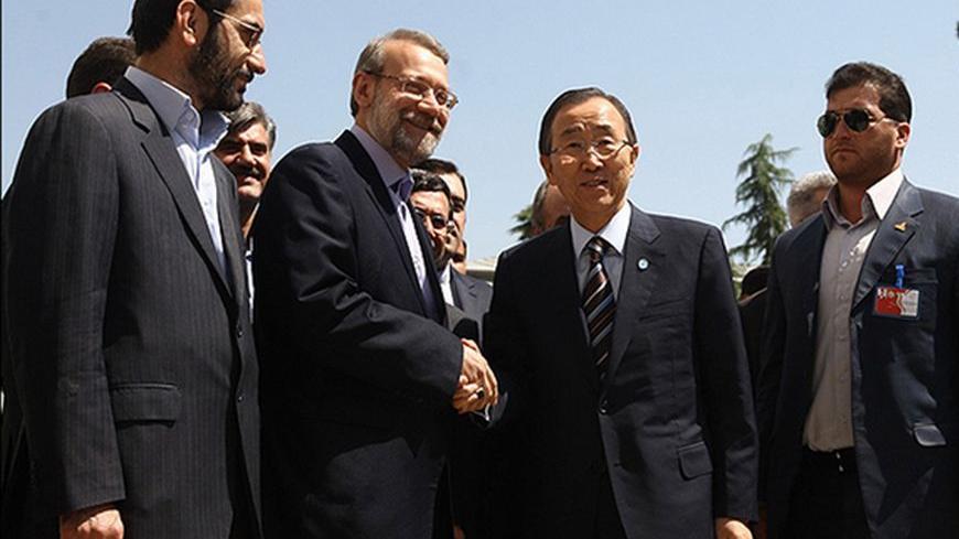 United Nations Secretary-General Ban Ki-moon (2nd R) shakes hands with Iran's parliamentary speaker Ali Larijani (3rd R) upon his arrival ahead of the 16th summit of the Non-Aligned Movement in Tehran, August 29, 2012. REUTERS/Mohsen Norouzifard/Mehr News Agency/Handout (IRAN - Tags: POLITICS) FOR EDITORIAL USE ONLY. NOT FOR SALE FOR MARKETING OR ADVERTISING CAMPAIGNS. THIS IMAGE HAS BEEN SUPPLIED BY A THIRD PARTY. IT IS DISTRIBUTED, EXACTLY AS RECEIVED BY REUTERS, AS A SERVICE TO CLIENTS
