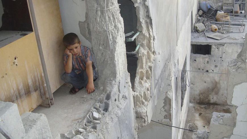 A boy sits at his parents' house, damaged by shelling by forces loyal to Syria's President Bashar al-Assad, in Talbiseh, near Homs August 31, 2012. Picture taken August 31, 2012.   REUTERS/Shaam News Network/Handout (SYRIA - Tags: POLITICS CIVIL UNREST CONFLICT TPX IMAGES OF THE DAY) FOR EDITORIAL USE ONLY. NOT FOR SALE FOR MARKETING OR ADVERTISING CAMPAIGNS. THIS IMAGE HAS BEEN SUPPLIED BY A THIRD PARTY. IT IS DISTRIBUTED, EXACTLY AS RECEIVED BY REUTERS, AS A SERVICE TO CLIENTS